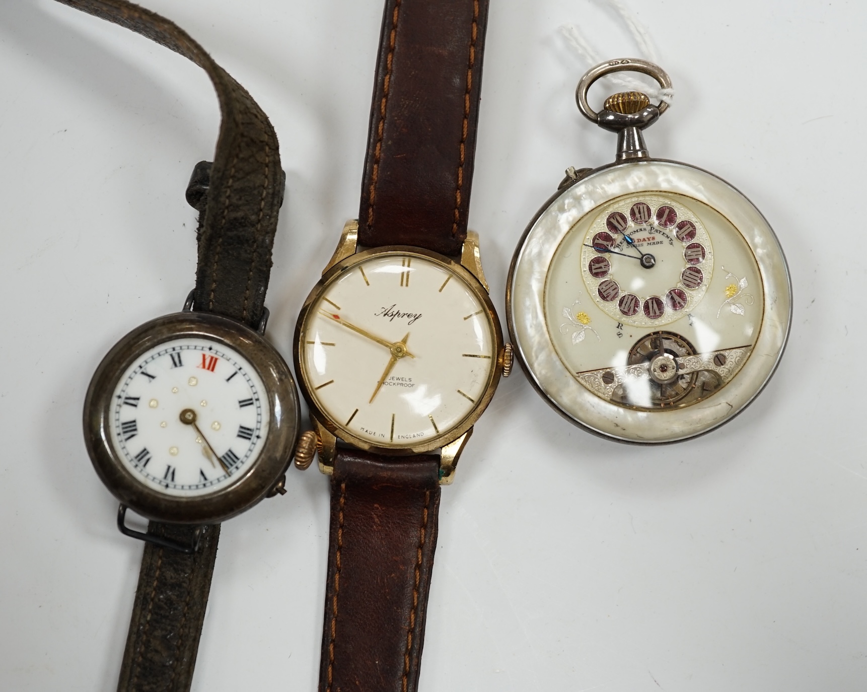 A gentleman's 9ct gold manual wind wrist watch, retailed by Asprey, together with a silver wrist watch and a mother of pearl cased Hebdomas pocket watch. Condition - poor to fair